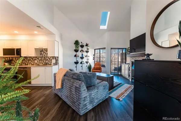 a living room with furniture and a mirror