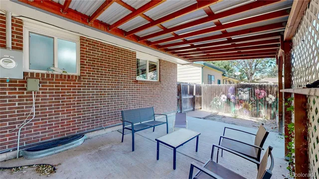 a view of a patio with a table and chairs and wooden floor