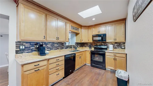 a kitchen with granite countertop white cabinets and white appliances