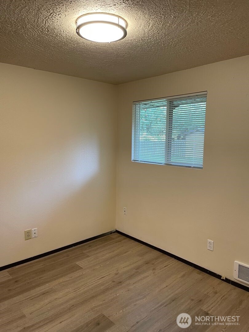 13317 28th Street Northeast, Unit A/B Lake Stevens, WA 98258 - Photo 11 of 14 an empty room with wooden floor and windows