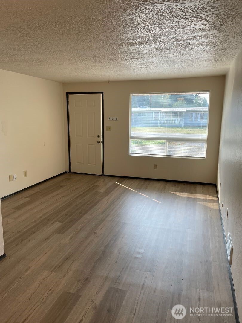 13317 28th Street Northeast, Unit A/B Lake Stevens, WA 98258 - Photo 4 of 14 an empty room with wooden floor and windows