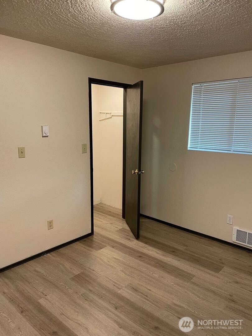 13317 28th Street Northeast, Unit A/B Lake Stevens, WA 98258 - Photo 8 of 14 an empty room with wooden floor and windows