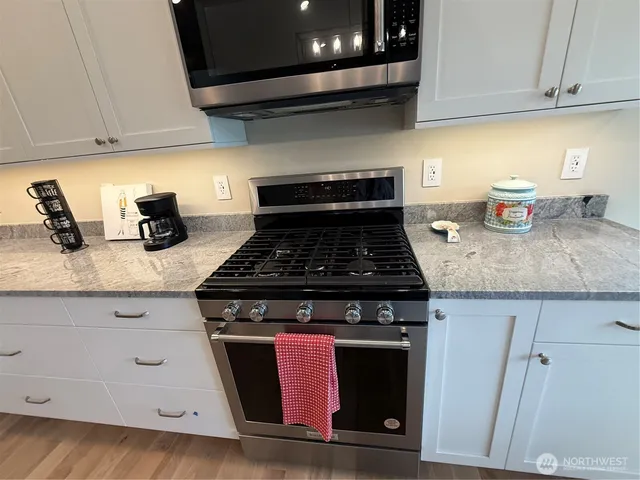 a stove top oven sitting inside of a kitchen