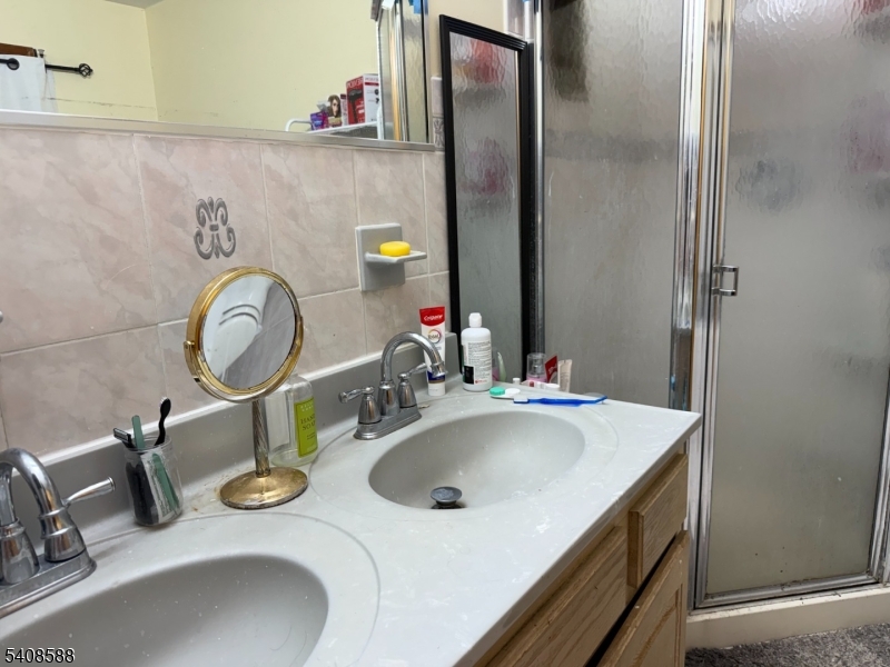 76 Passaic Avenue, Unit 76 Nutley, NJ 07110 - Photo 12 of 15 a bathroom with a sink and a mirror