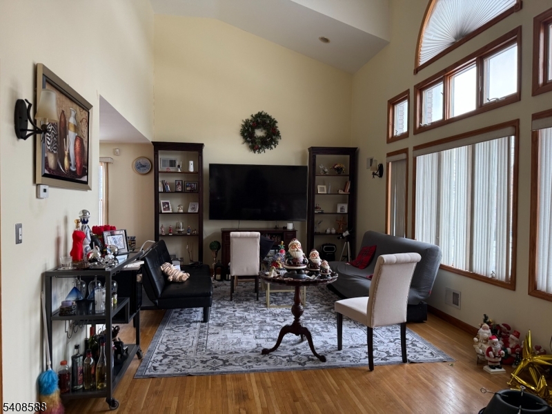 76 Passaic Avenue, Unit 76 Nutley, NJ 07110 - Photo 2 of 15 a living room with furniture and a flat screen tv