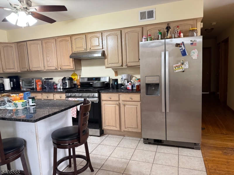 76 Passaic Avenue, Unit 76 Nutley, NJ 07110 - Photo 4 of 15 a kitchen with stainless steel appliances granite countertop a refrigerator a sink a stove and island