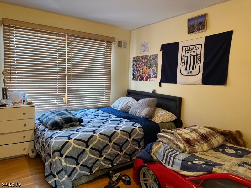 76 Passaic Avenue, Unit 76 Nutley, NJ 07110 - Photo 7 of 15 a bedroom with two bed and a window