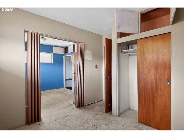 a view of a hallway with wooden cabinets