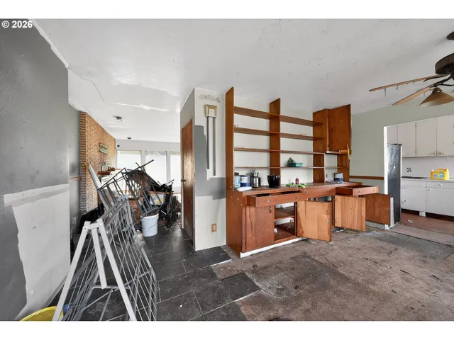 a kitchen with stainless steel appliances kitchen island granite countertop a refrigerator a stove a sink dishwasher with a dining table and chairs