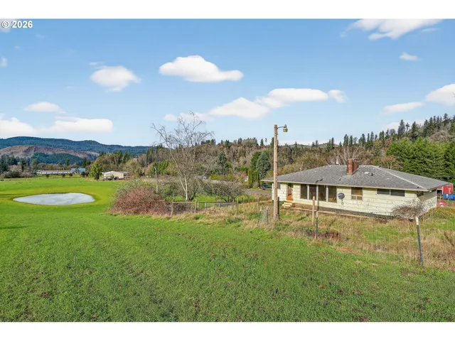 a view of a big yard with table and chairs