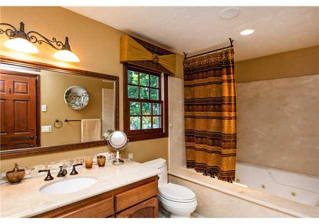 188 Candy Lane Encinitas, CA 92024 - Photo 17 of 25 Guest bath with granite counter, tile floor and oversized jetted tub/shower with stone surround.