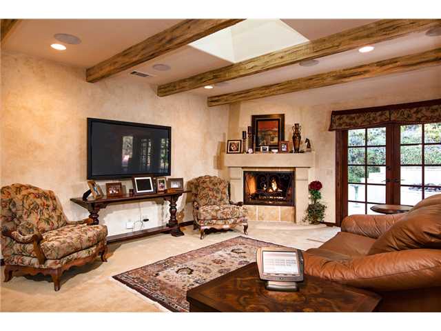 188 Candy Lane Encinitas, CA 92024 - Photo 10 of 25 Family room with beam ceiling, gas fireplace, skylight, built-in speakers and french doors that open out to the patio.