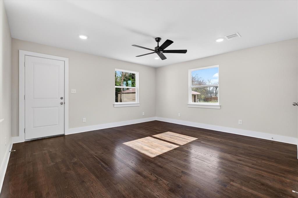 806 Denton Street Denton, TX 76201 - Photo 13 of 19 Empty room with dark wood finished floors, recessed lighting, and a ceiling fan