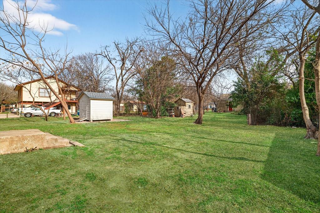 806 Denton Street Denton, TX 76201 - Photo 17 of 19 View of grassy yard featuring a storage shed
