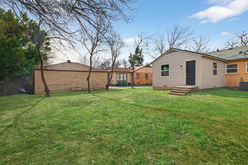 806 Denton Street Denton, TX 76201 - Photo 18 of 19 Back of house featuring a lawn, crawl space, a patio area, and entry steps