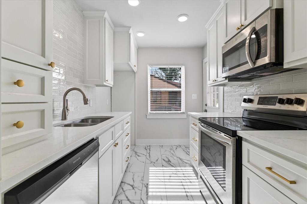 806 Denton Street Denton, TX 76201 - Photo 7 of 19 Kitchen with stainless steel appliances, light stone countertops, white cabinetry, recessed lighting, and decorative backsplash