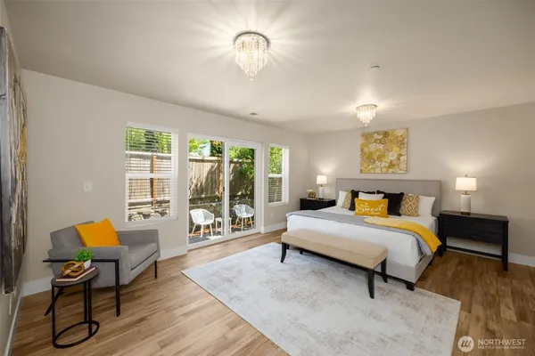 a spacious bedroom with a bed and large windows