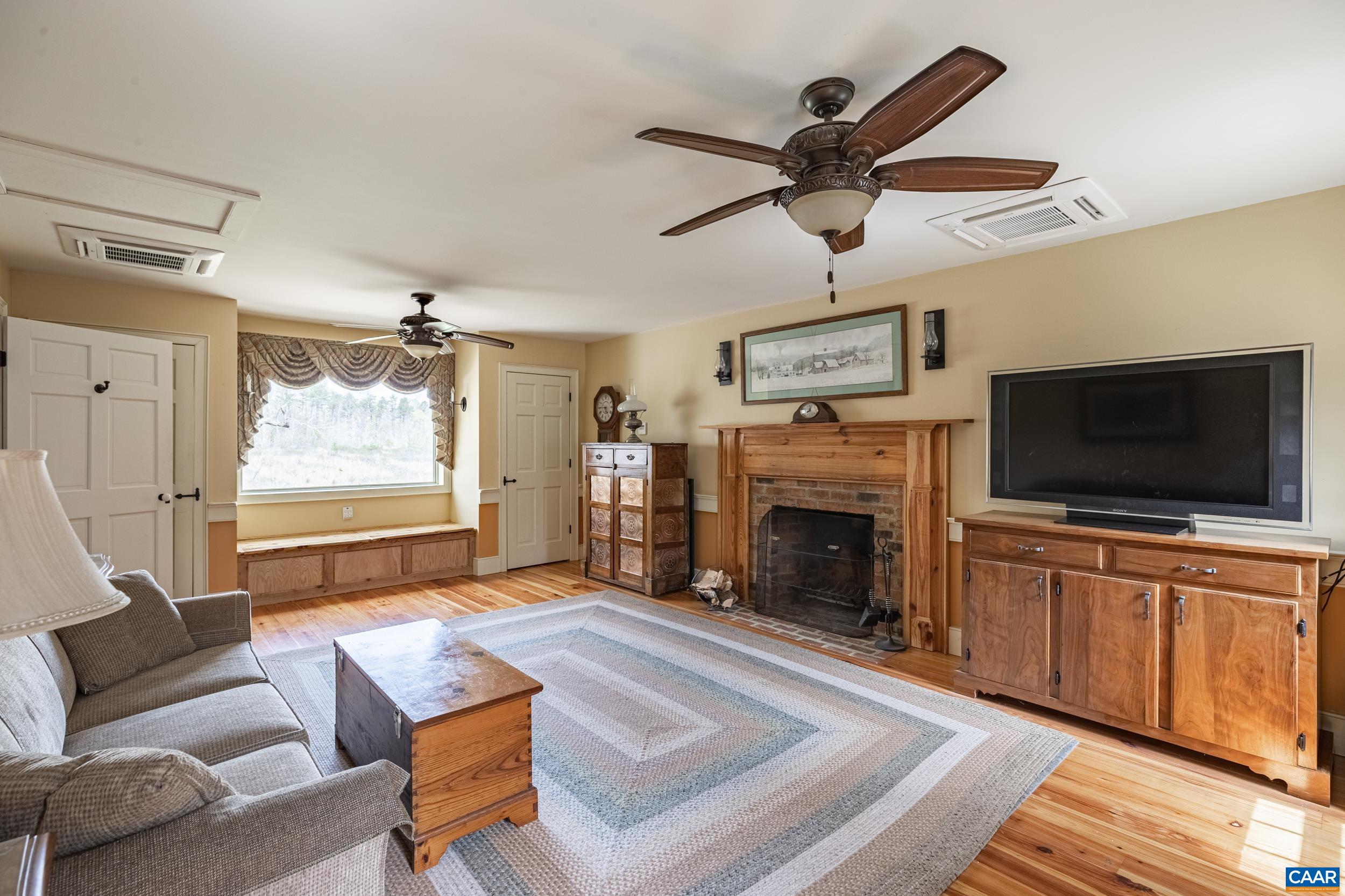 3100 Bacon School Road Saxe, VA 23967 - Photo 22 of 47 a living room with furniture a fireplace and a flat screen tv
