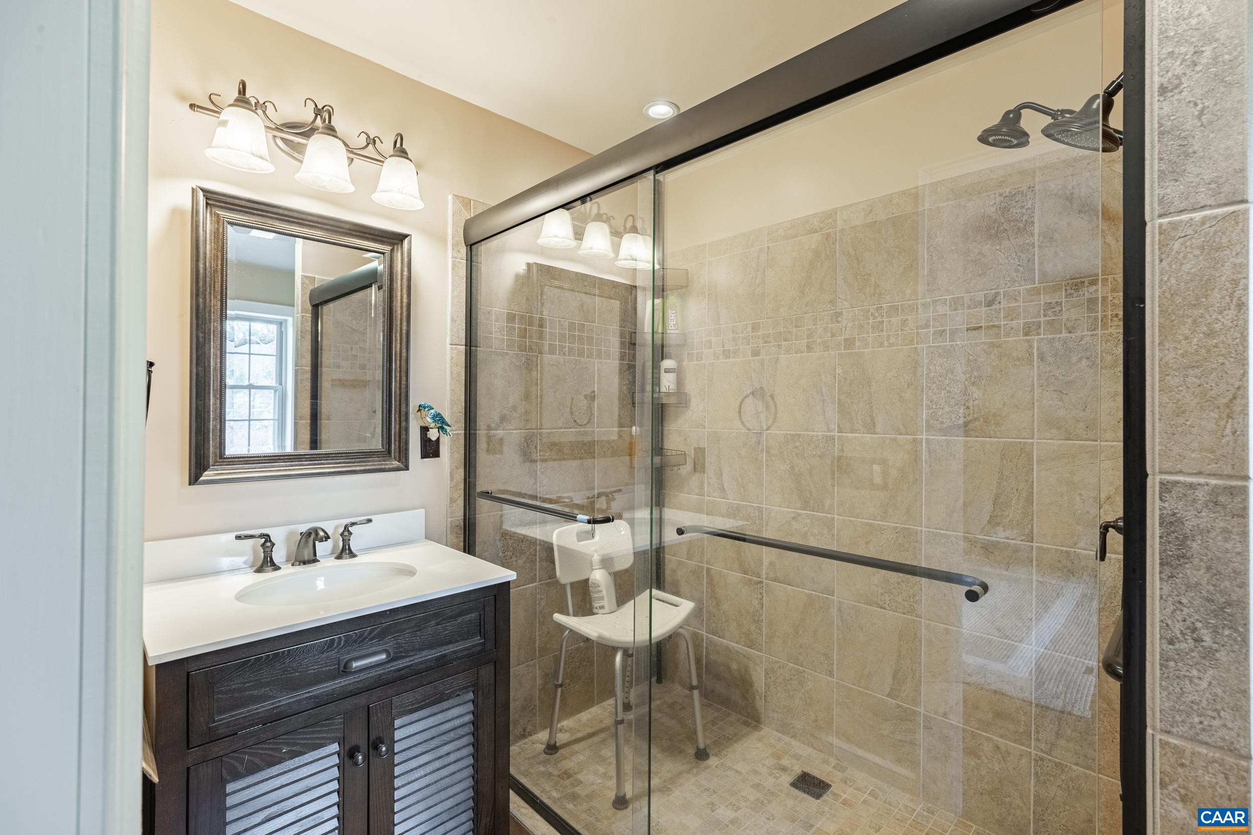 3100 Bacon School Road Saxe, VA 23967 - Photo 23 of 47 a bathroom with a double vanity sink toilet and shower