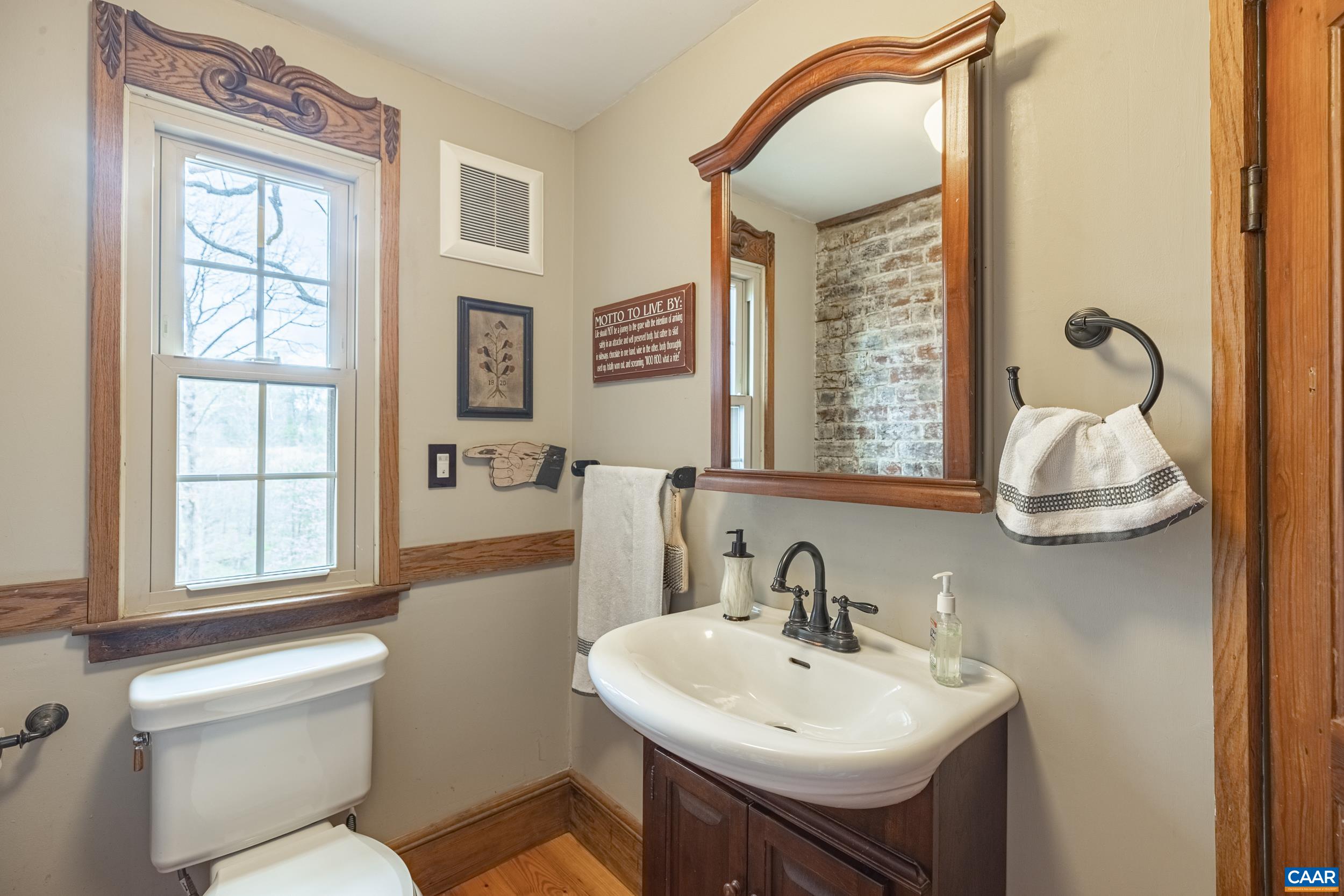 3100 Bacon School Road Saxe, VA 23967 - Photo 24 of 47 a bathroom with a sink a toilet and a mirror