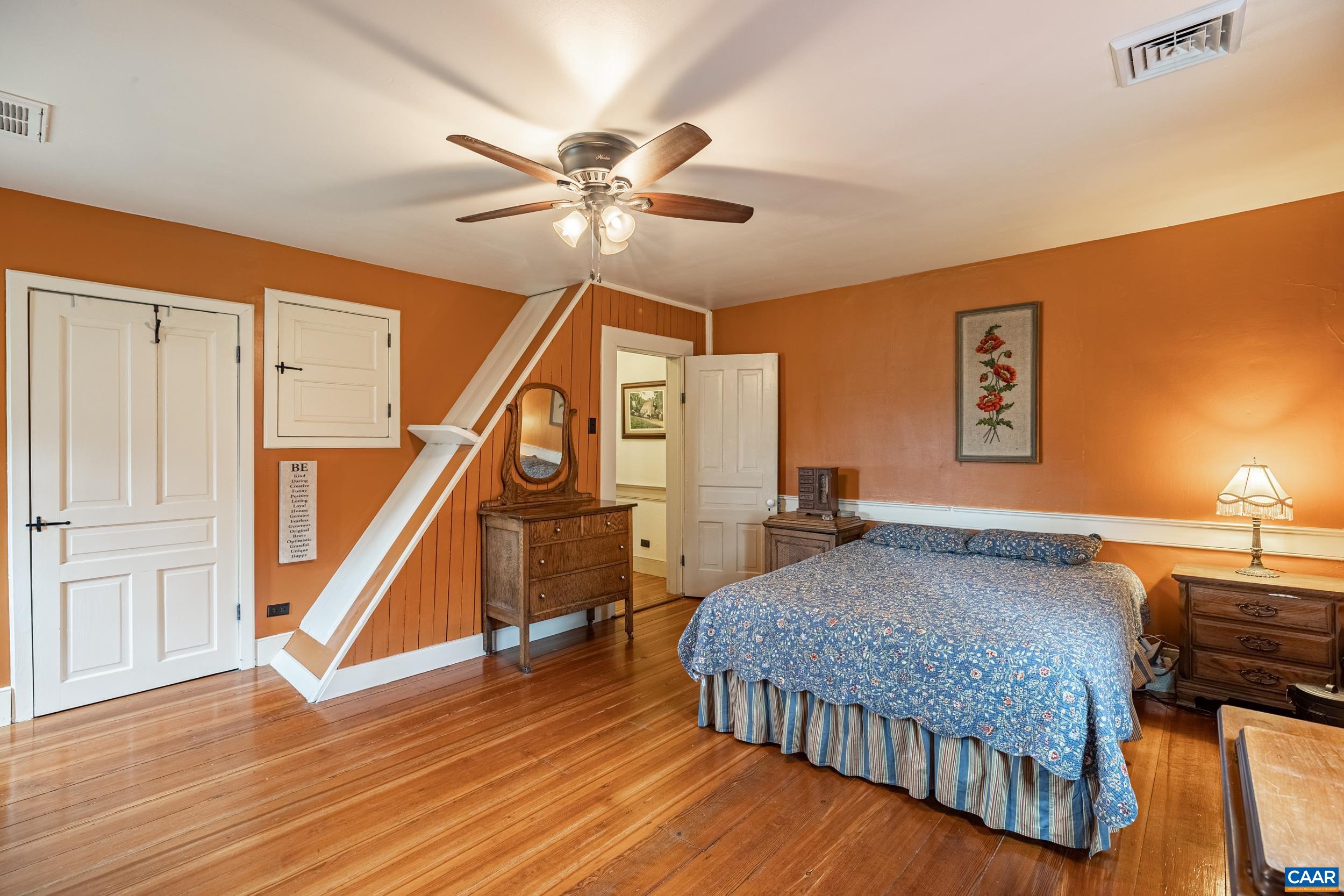 3100 Bacon School Road Saxe, VA 23967 - Photo 25 of 47 a bedroom with a bed and a chandelier