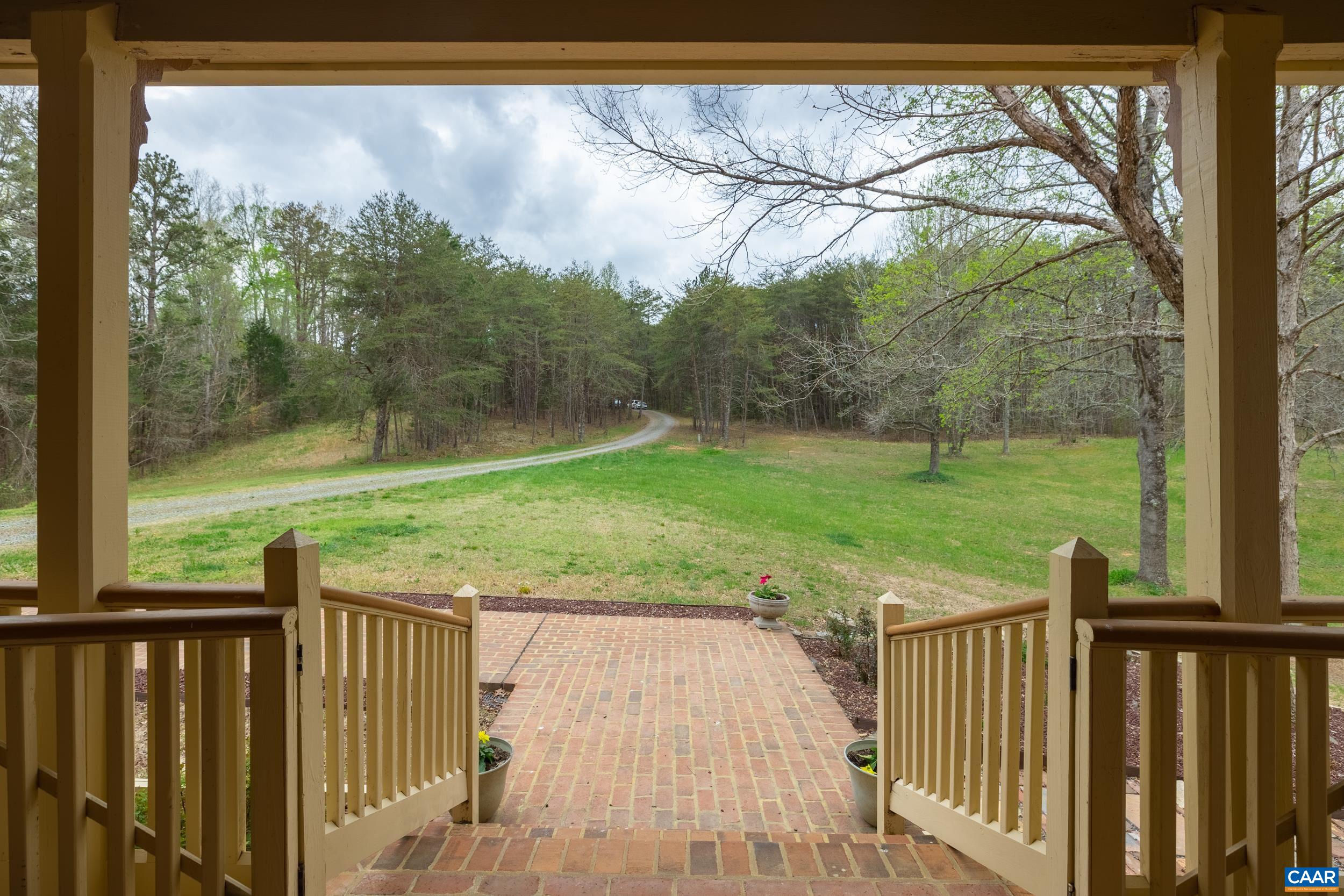 3100 Bacon School Road Saxe, VA 23967 - Photo 3 of 47 a view of a wooden deck with a yard and a fence