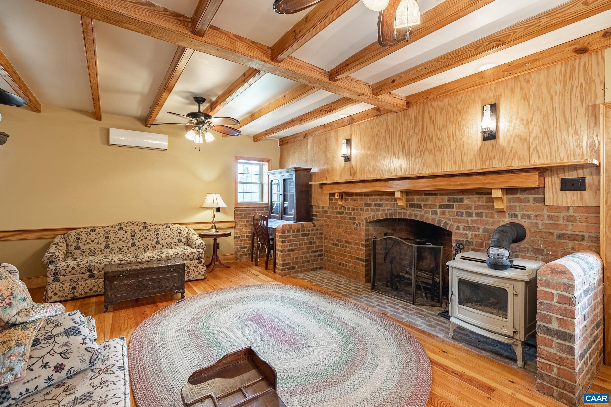 3100 Bacon School Road Saxe, VA 23967 - Photo 10 of 47 a living room with furniture and a fireplace
