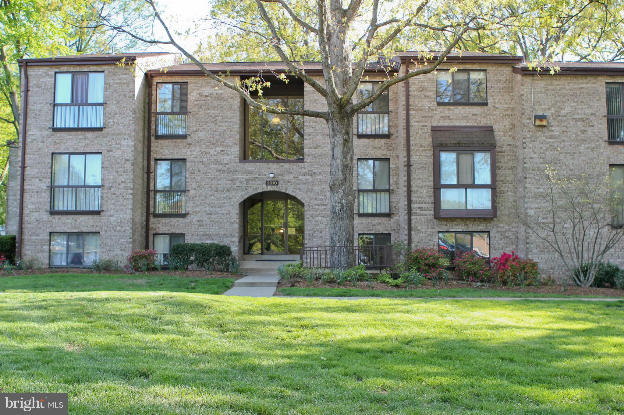 2010 Colts Neck Road, Unit 21B Reston, VA 20191 - Photo 1 of 25 a front view of a house with garden