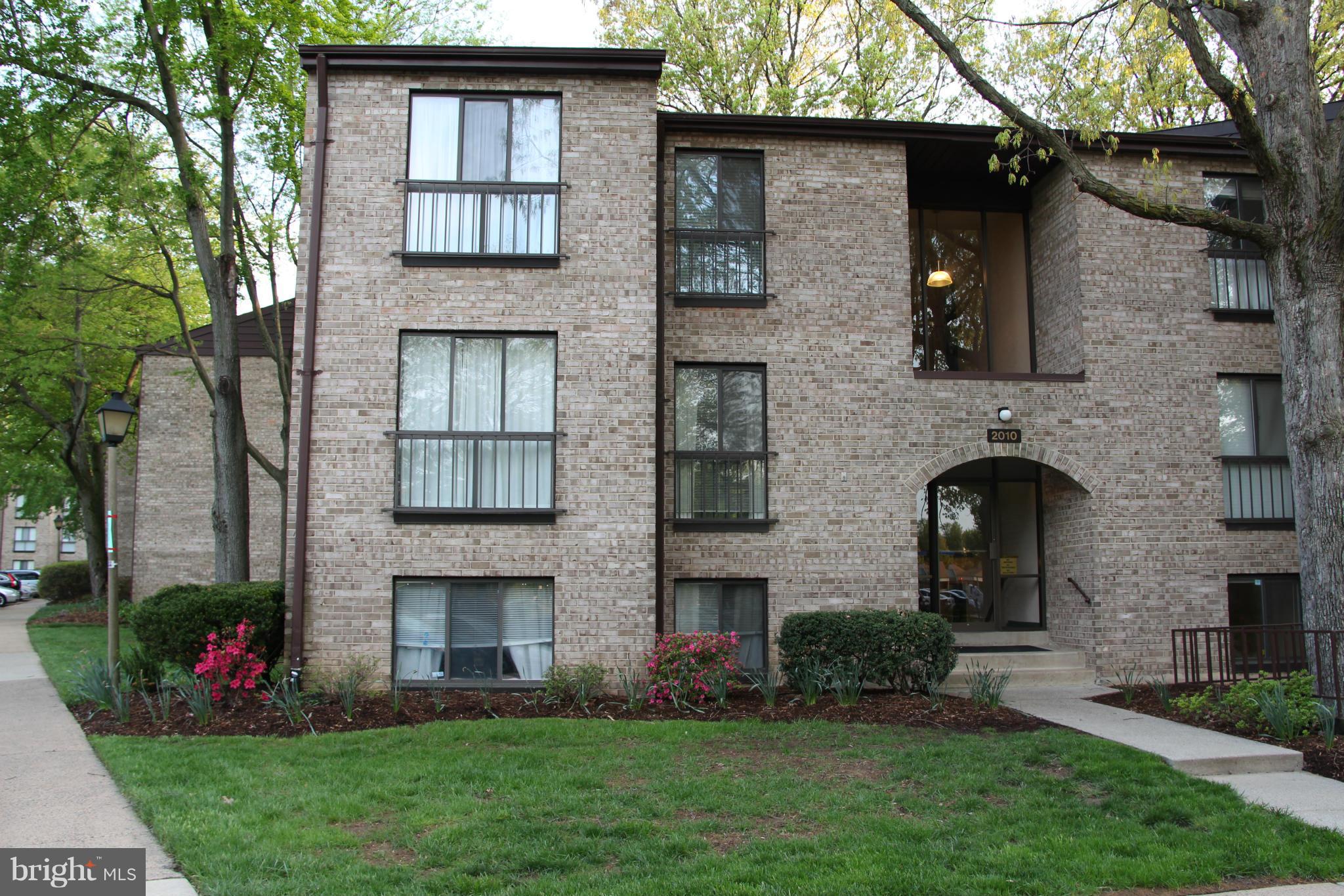 2010 Colts Neck Road, Unit 21B Reston, VA 20191 - Photo 2 of 25 a front view of a house with a garden and plants