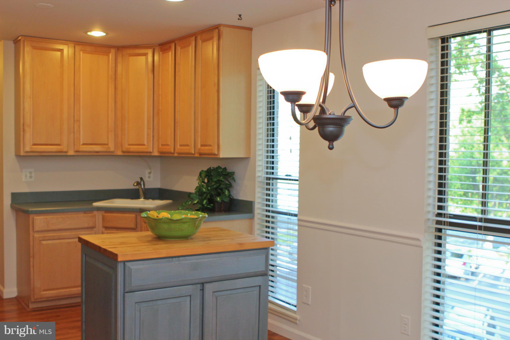 2010 Colts Neck Road, Unit 21B Reston, VA 20191 - Photo 5 of 25 a kitchen with a refrigerator and cabinets