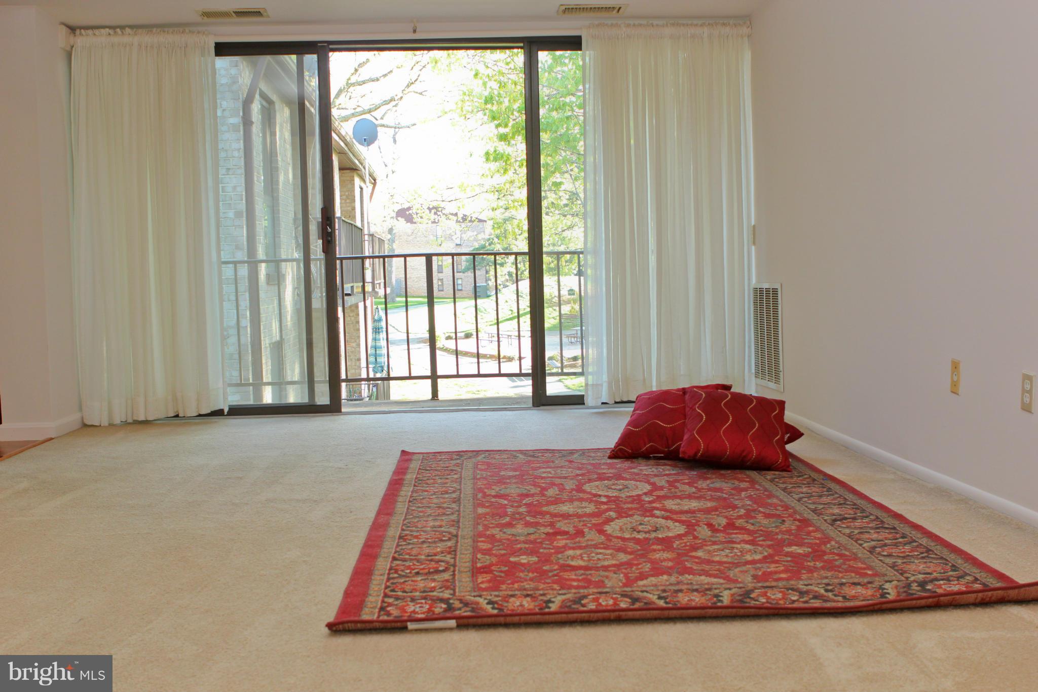 2010 Colts Neck Road, Unit 21B Reston, VA 20191 - Photo 8 of 25 a bed sitting in a bedroom next to a window