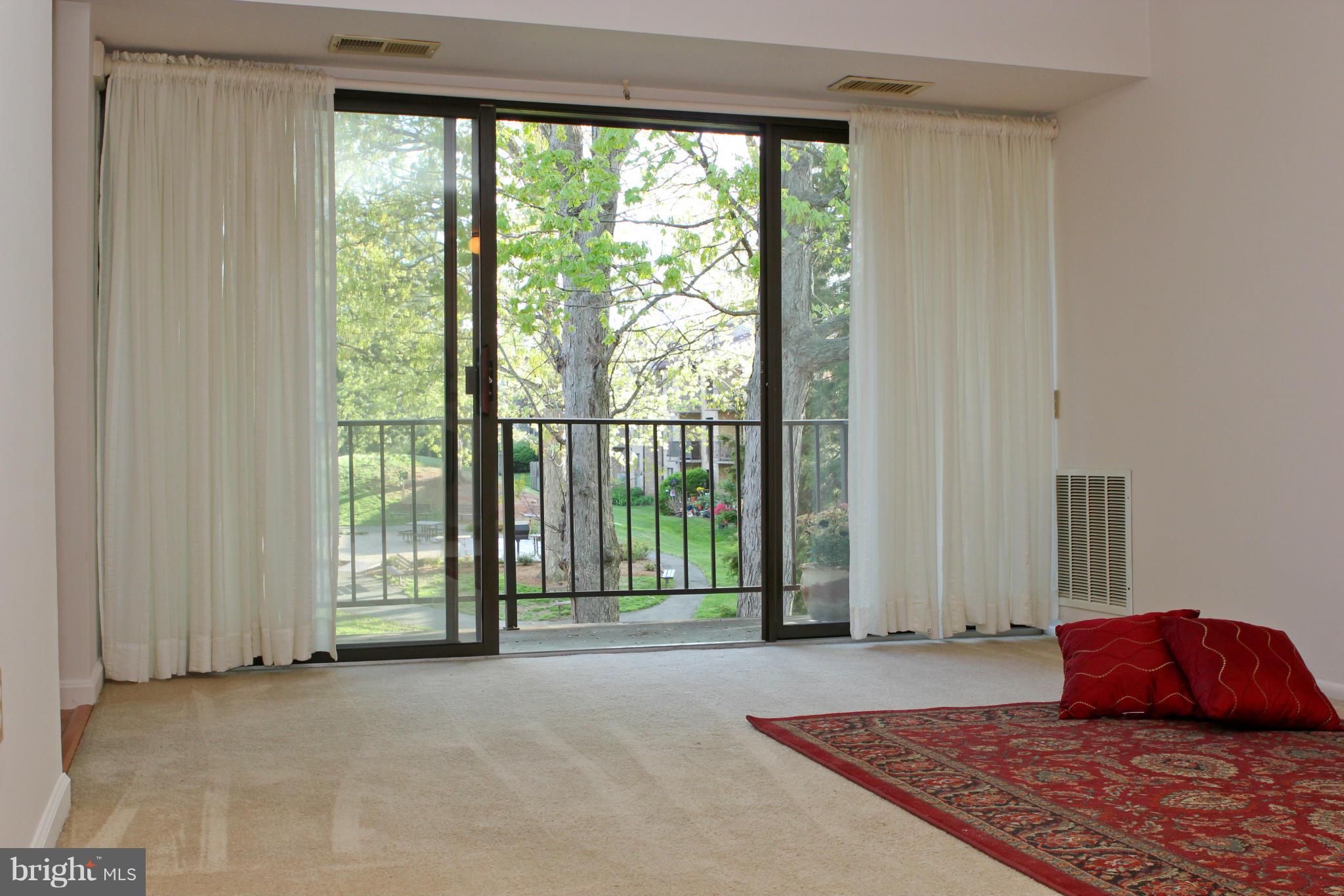 2010 Colts Neck Road, Unit 21B Reston, VA 20191 - Photo 9 of 25 a bedroom with a bed and a large window
