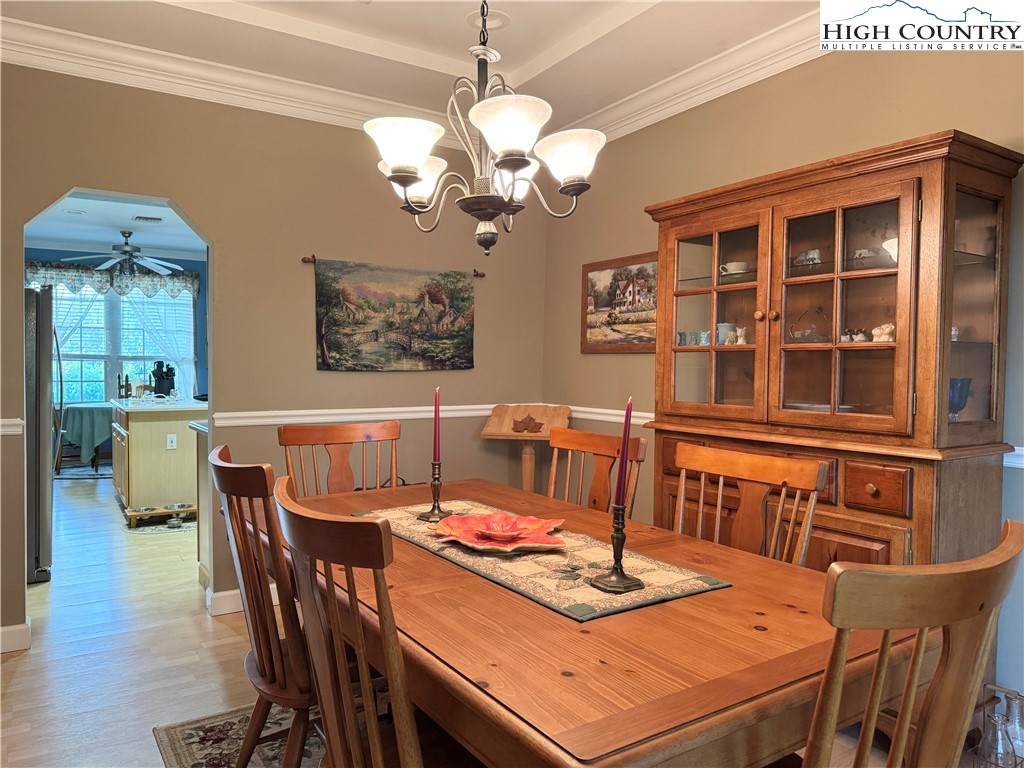 175 Olive Ridge Drive Crumpler, NC 28617 - Photo 17 of 50 a dining room with furniture a chandelier and wooden floor