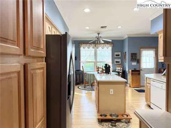 a room with kitchen island stainless steel appliances lots of counter top space