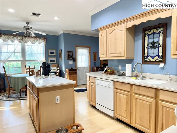 a kitchen with kitchen island a sink stove and cabinets