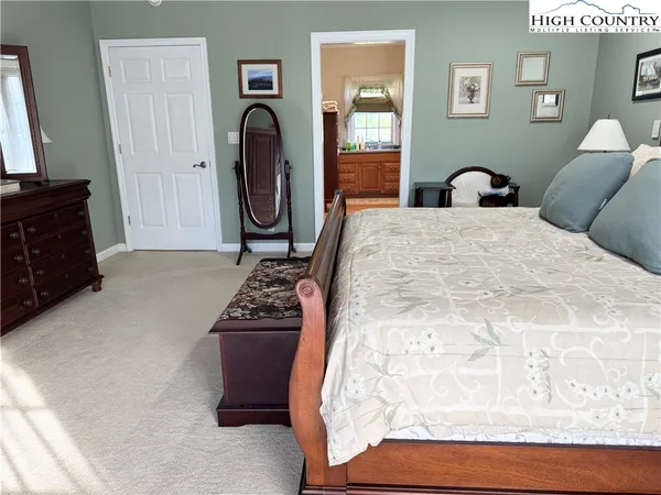 a bedroom with a bed and a mirror