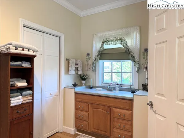 a bathroom with a granite countertop sink mirror vanity and a window