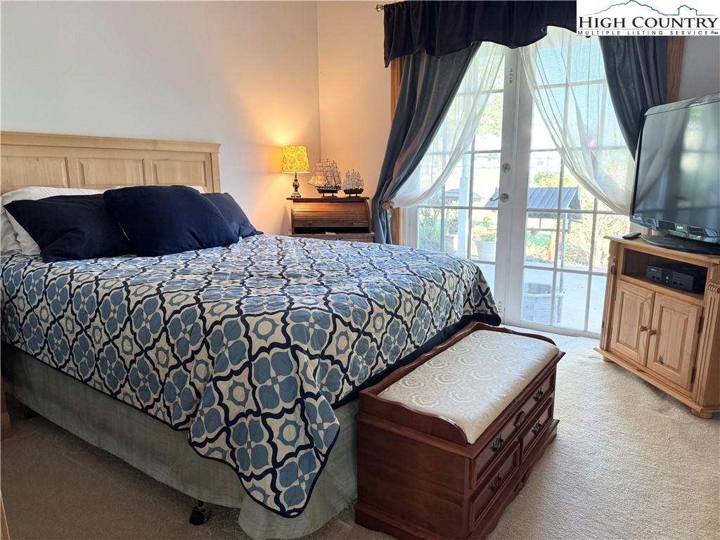 175 Olive Ridge Drive Crumpler, NC 28617 - Photo 32 of 50 a bedroom with a bed and a television