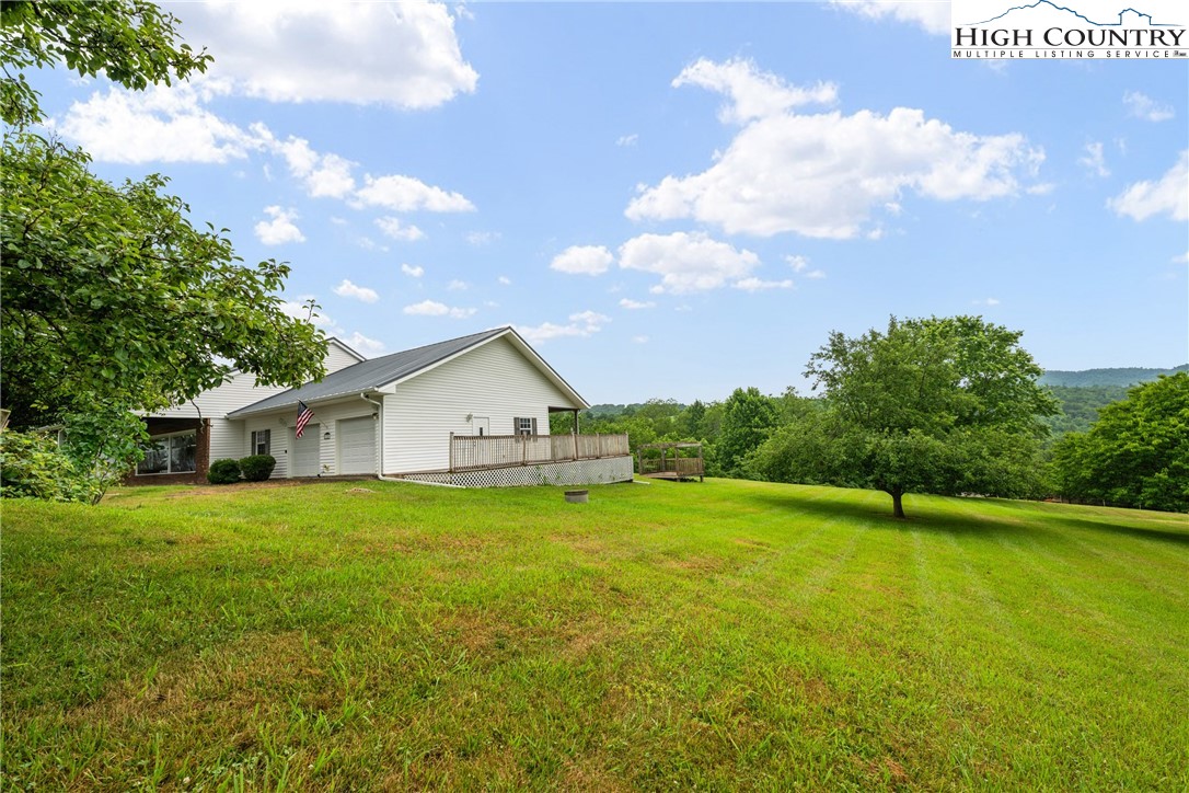 175 Olive Ridge Drive Crumpler, NC 28617 - Photo 39 of 50 a view of a house with a big yard and potted plants