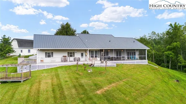 a front view of house with swimming pool and furniture