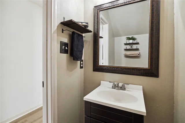 a bathroom with a sink a mirror and shower