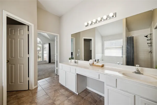 a bathroom with a double vanity sink mirror and
