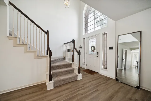 a view of an entryway with wooden floor and door