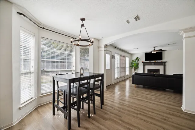 a view of a dining room with furniture window and wooden floor