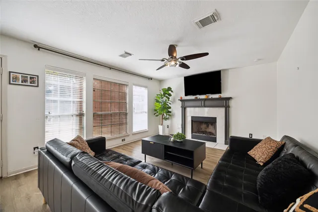 a living room with furniture a fireplace and a flat screen tv