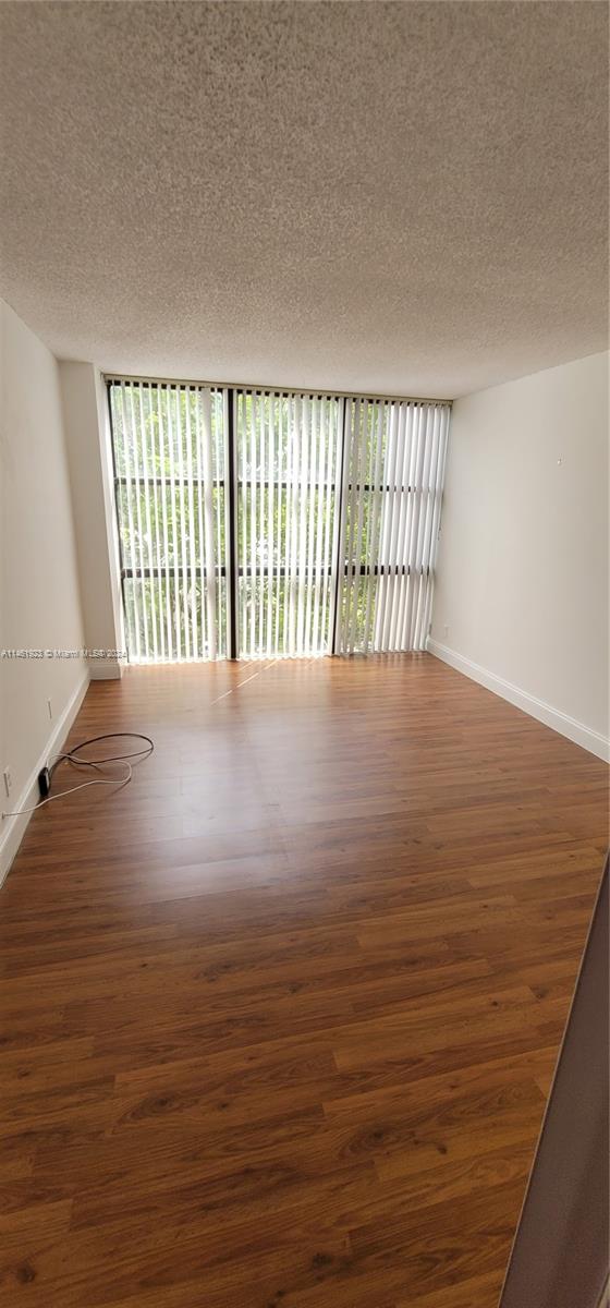 17021 North Bay Road, Unit 516 Sunny Isles Beach, FL 33160 - Photo 3 of 10 a view of an empty room with wooden floor