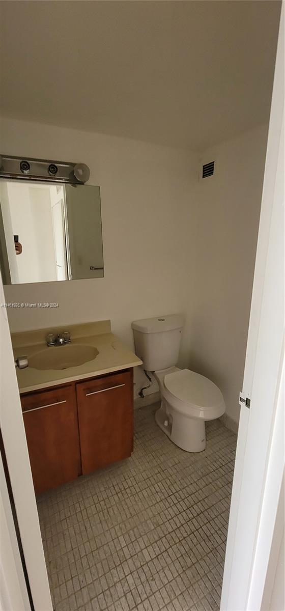 17021 North Bay Road, Unit 516 Sunny Isles Beach, FL 33160 - Photo 9 of 10 a bathroom with a granite countertop toilet and a sink