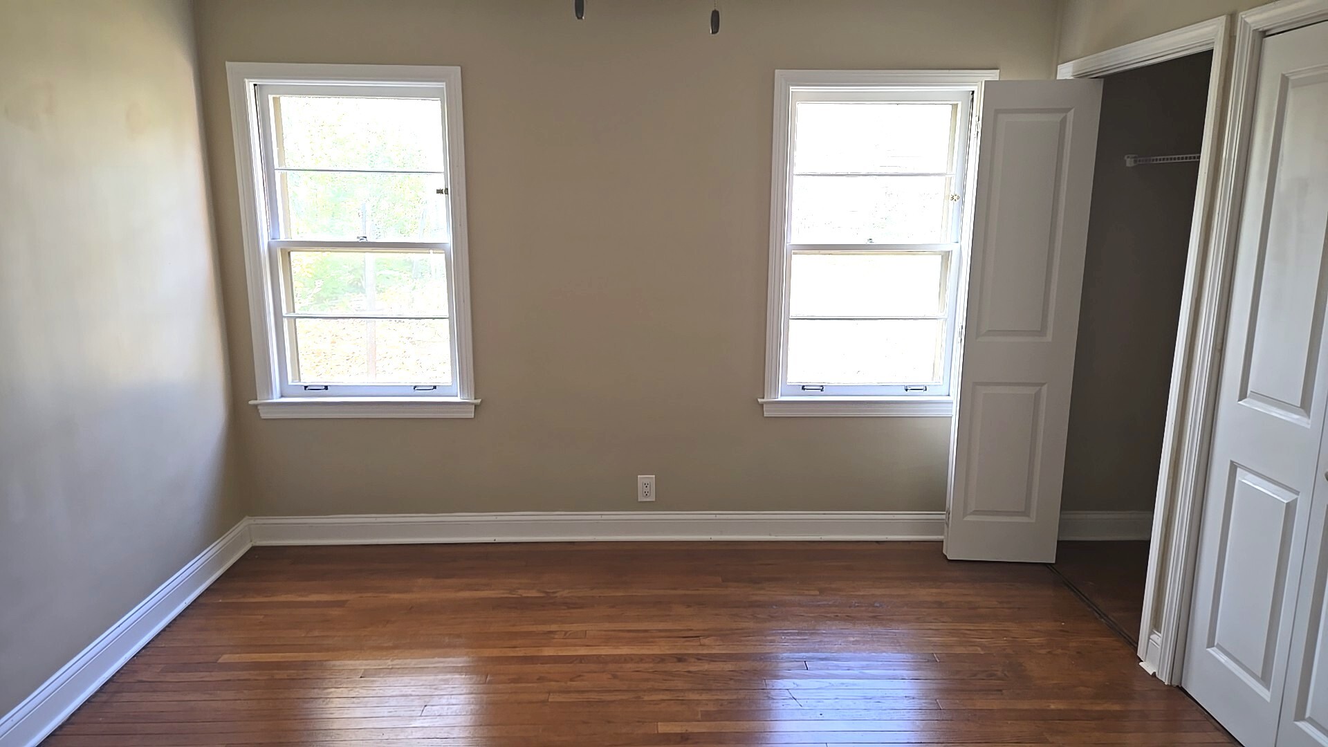 710 Bruce Avenue Flossmoor, IL 60422 - Photo 16 of 20 a view of an empty room with wooden floor and a window
