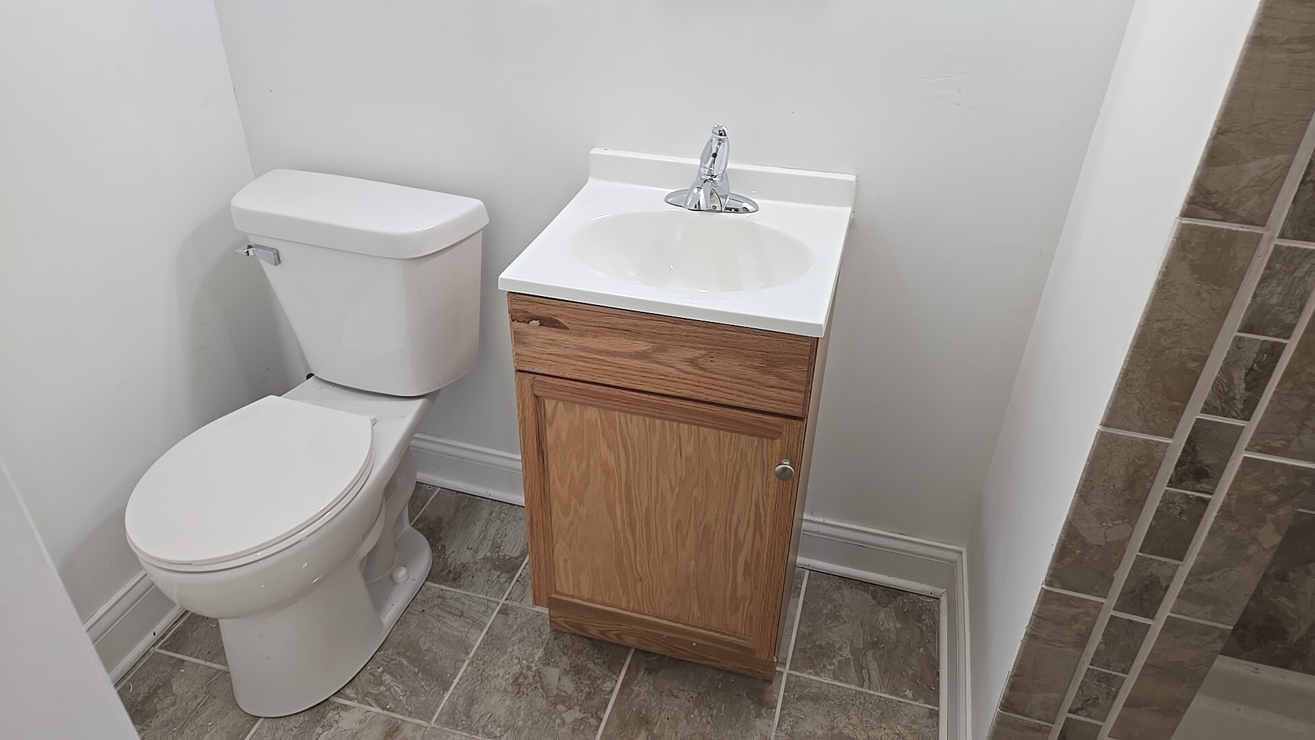 710 Bruce Avenue Flossmoor, IL 60422 - Photo 10 of 20 a white toilet sitting next to a sink and vanity