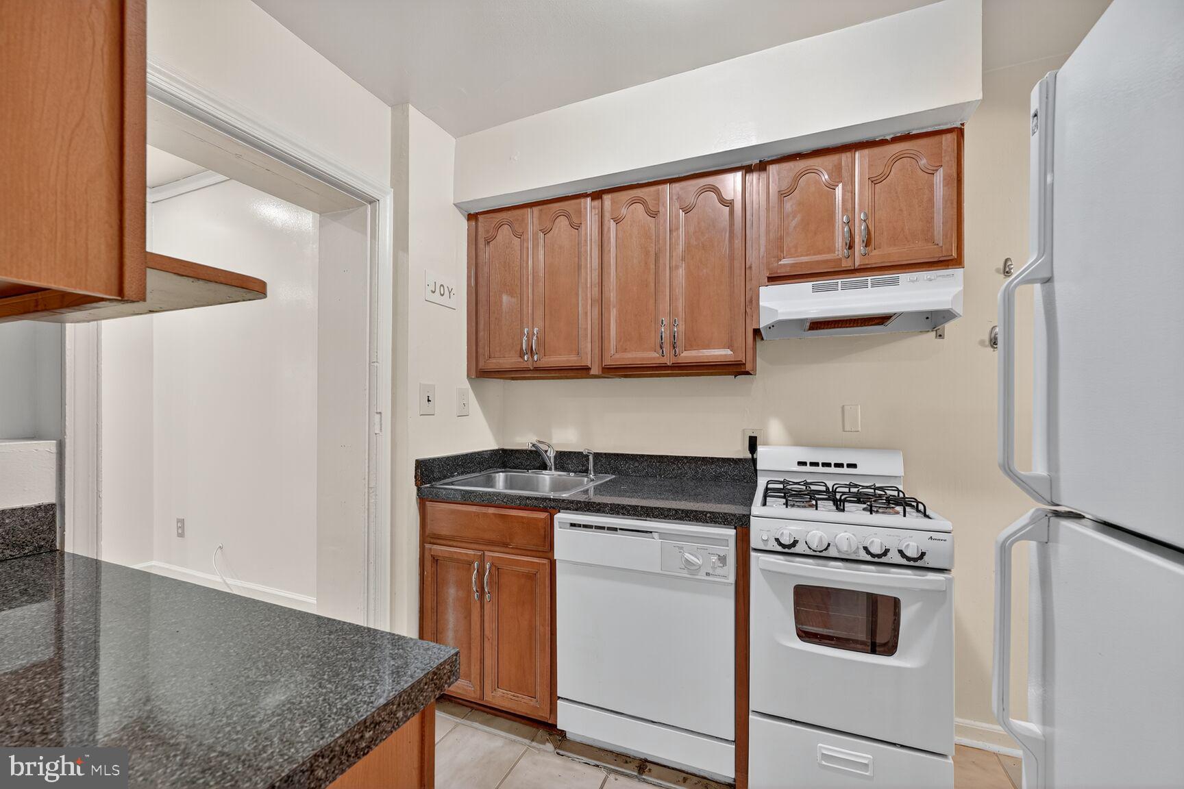 5720 5th Street Northeast Washington, DC 20011 - Photo 7 of 24 a kitchen with a stove and a microwave